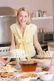 Woman at party standing by food table smiling