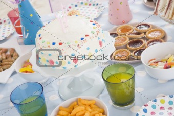 Birthday party table setting with food