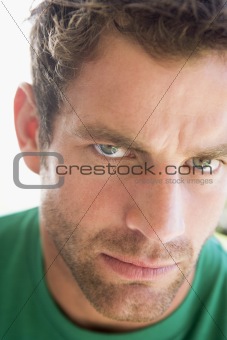 Head shot of man scowling