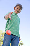 Young boy using yo yo outdoors smiling