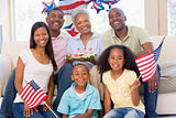 Family in living room on fourth of July with flags and cookies s