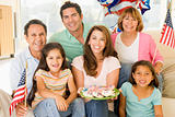 Family in living room on fourth of July with flags and cookies s