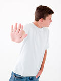 Teenage boy standing with hand up