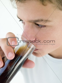 Young boy drinking soda