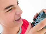 Teenage boy using videogame controller