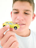 Young boy holding toy car and smiling