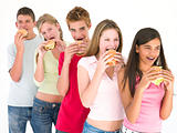 Row of five friends eating hamburgers
