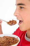 Boy eating chocolate puff cereal
