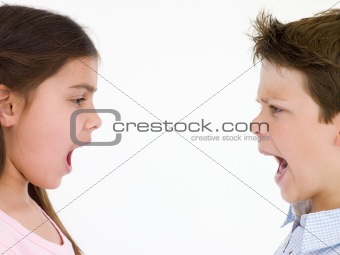Brother and sister looking at each other shouting