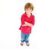 Young boy with arms crossed scowling