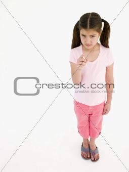 Young girl pointing and frowning
