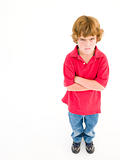Young boy with arms crossed angry