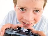 Young boy using videogame controller smiling