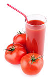 Full glass of fresh tomato juice with straw and tomatoes