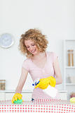 Gorgeous red-haired woman cleaning a cutting board in the kitche