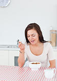 Cute woman eating cereal