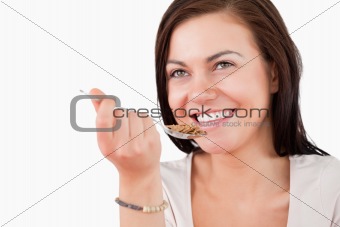 Close up of a charming woman eating cereal