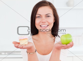 Young woman with an apple and a piece of cake