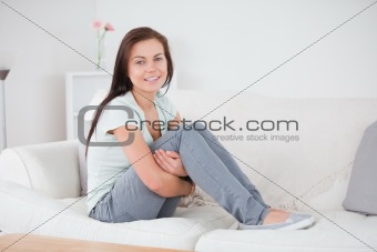 Close up of a young woman posing on her sofa