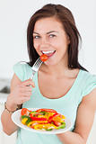 Young woman eating a salad