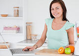 Woman with a laptop and fruits