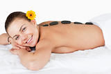 Smiling woman having a hot stone massage