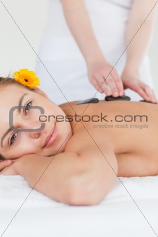 Portrait of a delighted woman having a hot stone massage