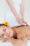 Portrait of a woman enjoying a hot stone massage