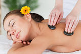 Close up of a beautiful woman enjoying a hot stone massage