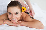 Smiling woman enjoying a hot stone massage