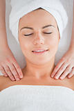Delighted woman having a shoulder massage