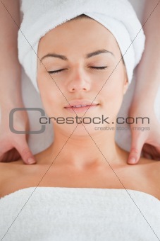 Delighted brunette having a shoulder massage