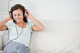 Smiling young woman listening to music