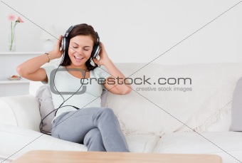 Smiling brunette listening to music