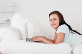 Cute woman on a sofa with a laptop