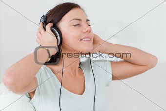 Charming brunette listening to music