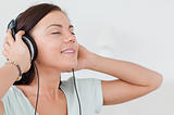 Close up of a charming brunette listening to music