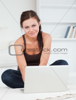 Beautiful dark-haired woman using her laptop