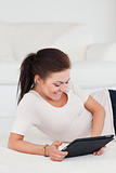 Smiling dark-haired woman using a tablet