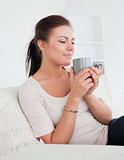 Cute brunette enjoying a cup of tea