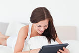Smiling young woman with a tablet