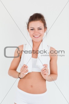 Fit woman with a towel on her shoulders