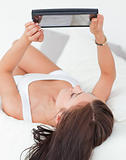 Portrait of  a beautiful brunette with a tablet