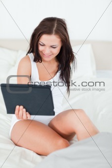 Smiling brunette with a tablet