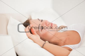 Brunette sleeping in her bed