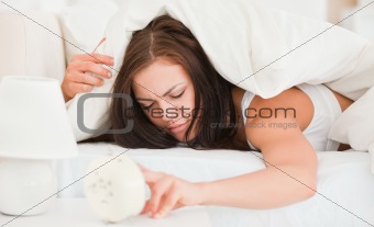 Unhappy cute brunette waking up