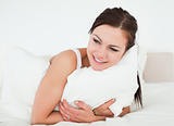 Young woman holding a pillow
