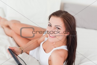 Close up of a cute brunette with a tablet