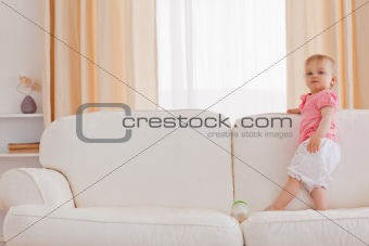 Baby standing on a sofa