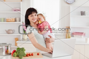 Lovely woman holding her baby in her arms